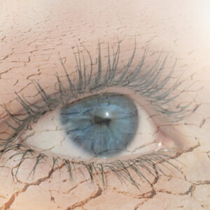 Double exposure of human eye in dry land on the background. Global warming and nature conservation concept